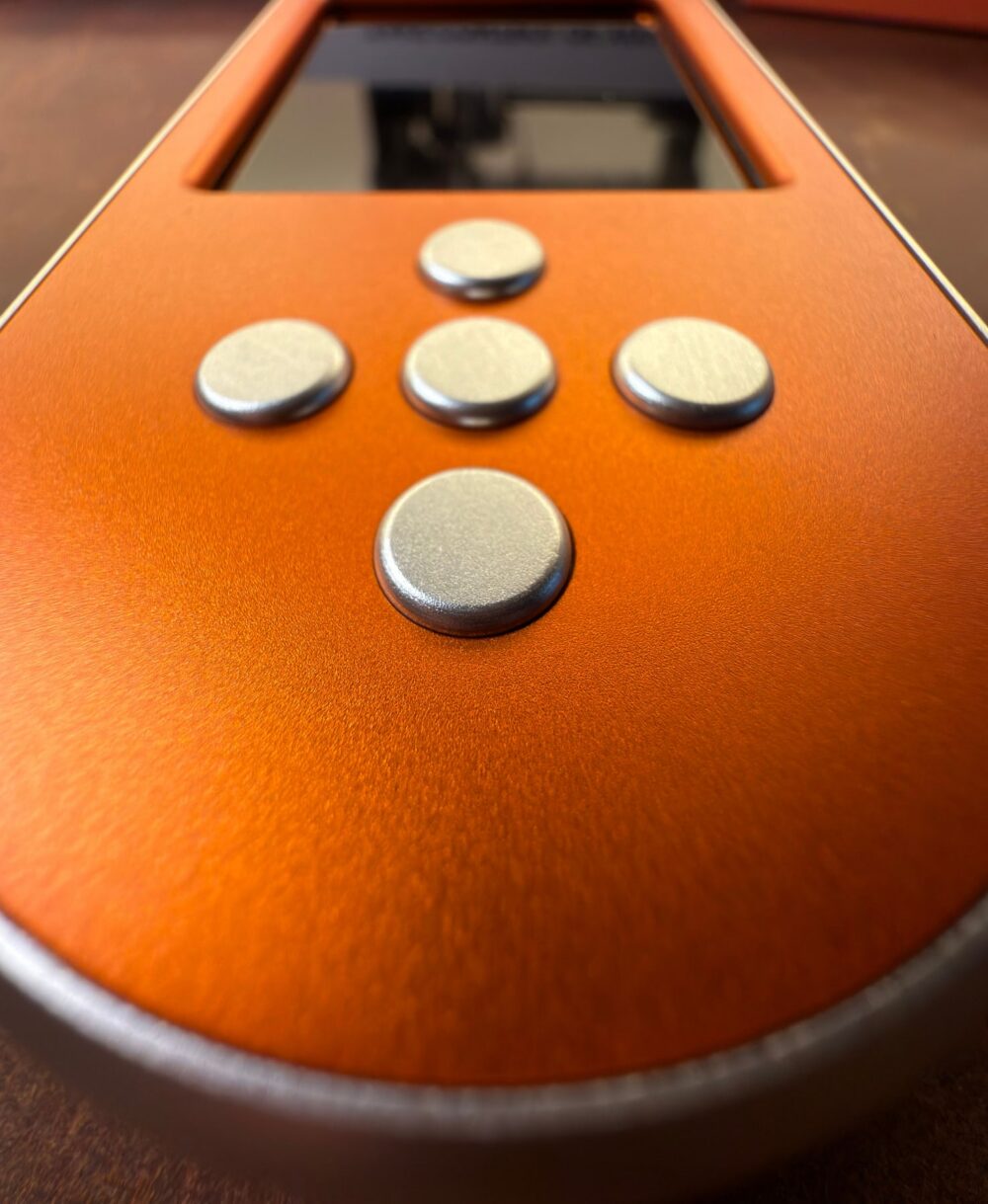 Close up of the silver buttons on the orange SeedSigner+ Premium