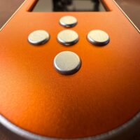 Close up of the silver buttons on the orange SeedSigner+ Premium
