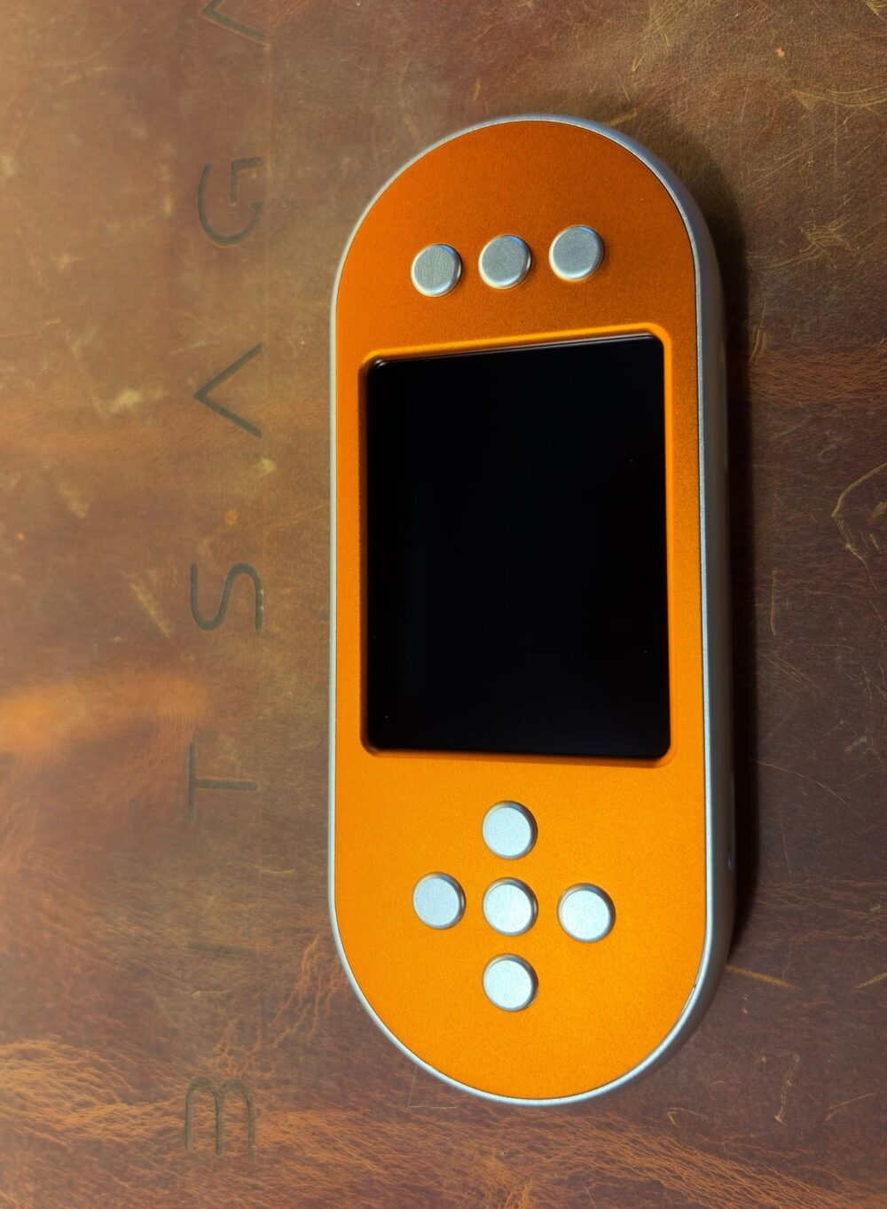 SeedSigner+ Premium in an orange anodised case with silver buttons