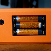 Rear battery compartment with three AAA batteries